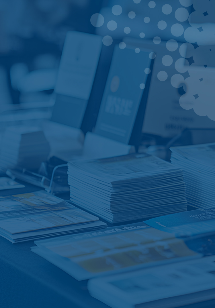selection of brochures and leaflets on a desk on blue background