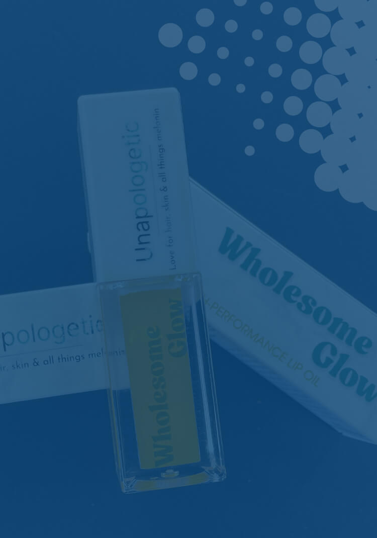 Bottle of Wholesome Glow lip oil with product packaging on a blue background